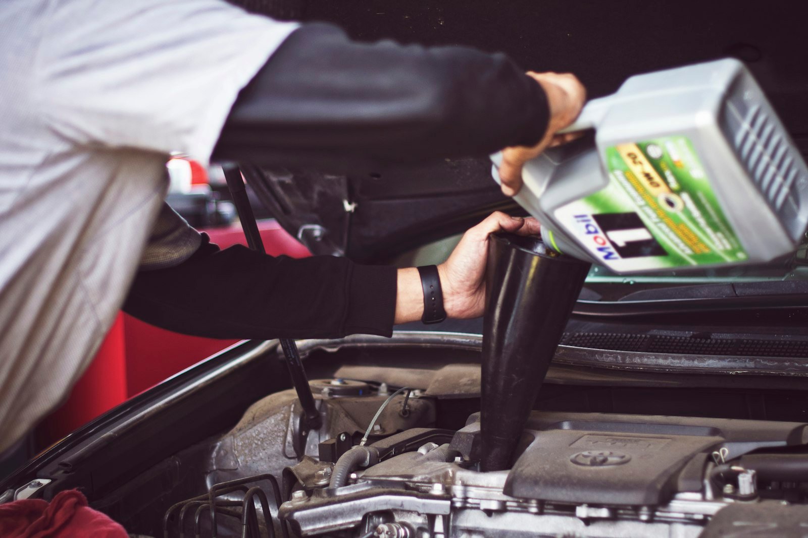 Certified Mississauga mechanic inspecting a serpentine belt in an engine bay at Sahara Motors