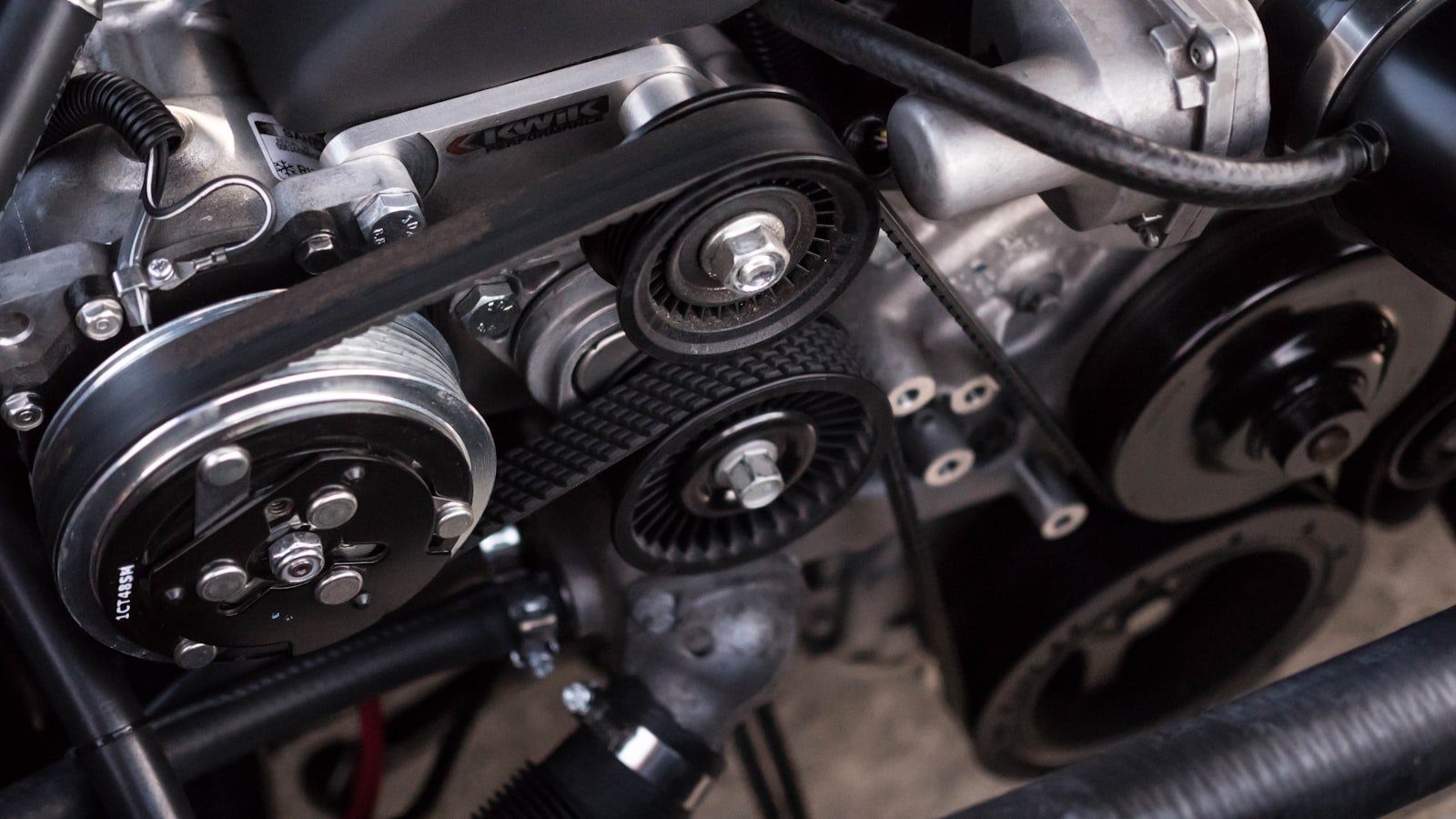 Mechanic inspecting a timing belt during service at a Mississauga auto shop